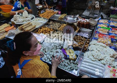 Bangkok, Thailand. 20th Jan, 2023. A woman seen selling Chinese various types of fish cake, meatball, and tofu at Bangkok's Chinatown fresh market. Bangkok's Chinatown (Yaowarat) fresh market became lively and full of Thai-Chinese people buying foods for worshipping their ancestor spirit during the Chinese New Year. Credit: SOPA Images Limited/Alamy Live News Stock Photo