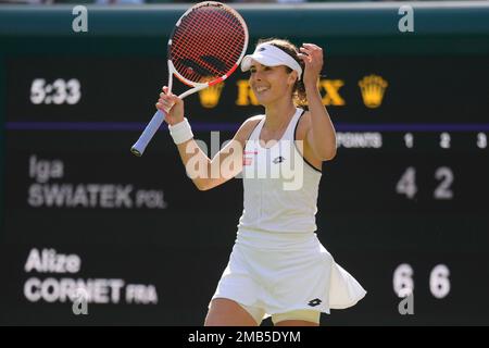 Alize Cornet of France celebrates beating Serena Williams of the