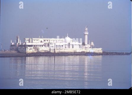 The Haji Ali Dargah is a mosque and dargah or the monument of Pir Haji Ali Shah Bukhari located on an islet off the coast of Worli in the southern Mumbai. An exquisite example of Indo-Islamic Architecture, associated with legends about doomed lovers, the dargah contains the tomb of Haji Ali Shah Bukhari. Stock Photo