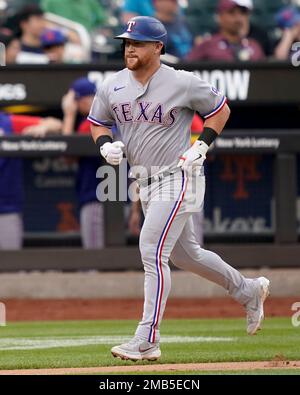 Texas Rangers right fielder Kole Calhoun throws during the second inning of  a spring training baseball game against the Seattle Mariners Monday, March  28, 2022, in Peoria, Ariz. (AP Photo/Charlie Riedel Stock