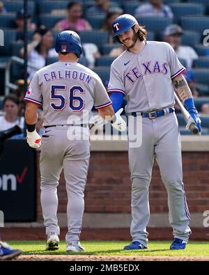 Texas Rangers' Kole Calhoun (56), Leody Taveras (3) and Bubba Thompson (65)  celebrate the team's 3-2 win in the second baseball game of a doubleheader  against the New York Yankees in Arlington