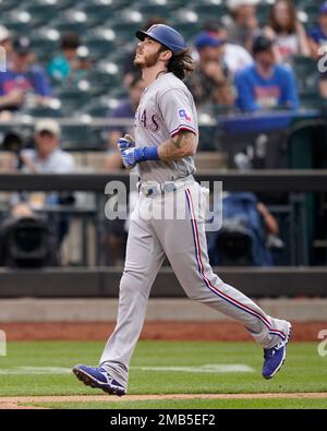 Texas Rangers catcher Jonah Heim throws the ball back to the pitcher during  an opening day baseball game against the Philadelphia Phillies Thursday,  March 30, 2023, in Arlington, Texas. (AP Photo/Jeffrey McWhorter