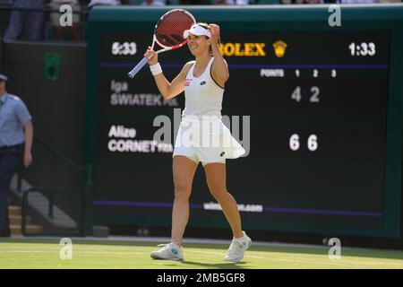 Alize Cornet of France celebrates beating Serena Williams of the