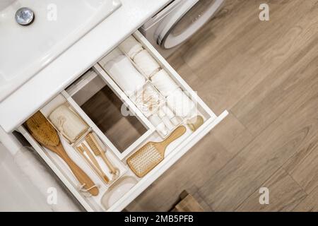 Bathroom under sink organizer drawers with neatly placed bath amenities and  toiletries Stock Photo - Alamy