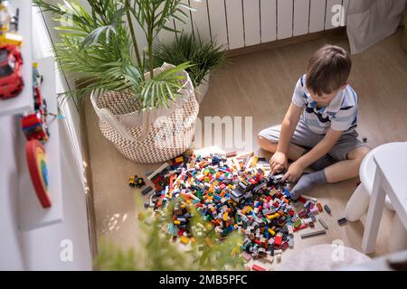 Khabarovsk, Russia, August 05, 2022. Male kid constructing toy cars and use Lego Classic Stock Photo