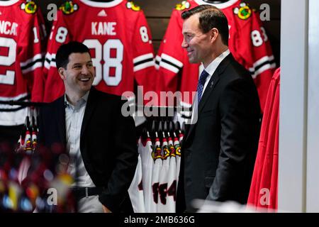Chicago Blackhawks NHL hockey team general manager Kyle Davidson, left, and  new head coach Luke Richardson hold up a jersey during a news conference in  Chicago, Wednesday, June 29, 2022. Richardson becomes