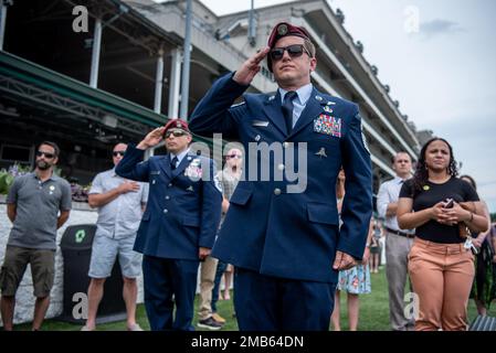 More than 150 Airmen, friends and family members attend Military Appreciation Day at Churchill Downs in Louisville, Ky., June 12, 2022, to honor Tech. Sgt. Travis Brown, a pararescueman from the Kentucky Air National Guard’s 123rd Special Tactics Squadron who died Feb. 16. One of the races on the day's card was named in honor of Brown and concluded with eight of his fellow 123rd STS Airmen presenting the trophy. Stock Photo