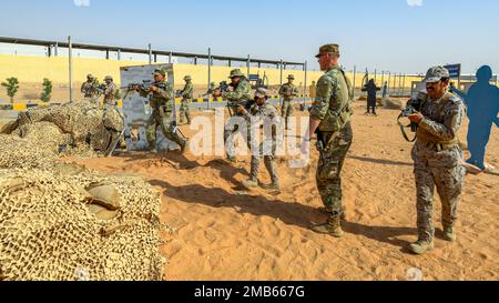 U.S. Soldiers assigned to Task Force Hurricane from the 1st Battalion, 124th Infantry Regiment, and Royal Saudi Land Force soldiers move in line during a platoon immersion in Al-Kharj, Kingdom of Saudi Arabia, June 12, 2022. The immersion was a training event meant to build interoperability between the U.S Army and RSLF at the platoon level while enhancing both U.S. and partner nation skillsets. Stock Photo