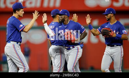 Texas Rangers' Corey Seager, left, Jonah Heim, center, and Marcus Semien,  right, celebrate their win in a baseball game against the Minnesota Twins,  Friday, July 8, 2022, in Arlington, Texas. (AP Photo/Tony