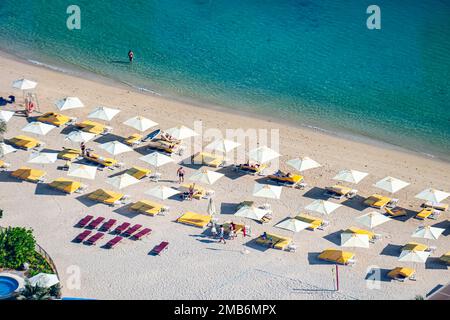 Summer seascape. Aerial top view of sea, beach, sand, umbrellas and tourists. Stock Photo