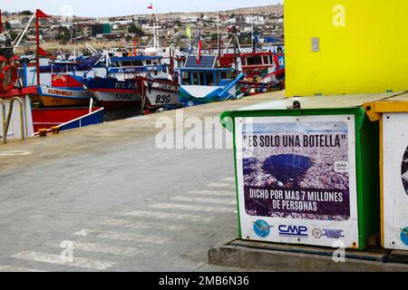 Sign in fishing docks encouraging people and fishermen not to throw plastic bottles into the sea, Caldera, Chile. The Spanish translates as 'It's only one bottle, said more than 7 million people'. Stock Photo