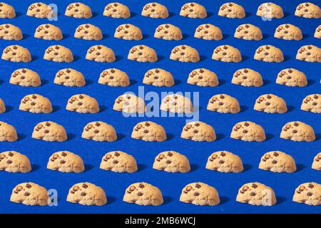 Homemade cookie with chocolate. Photo on a blue background. Modern food concept. Place for text. Photo of cookies as a pattern. Stock Photo