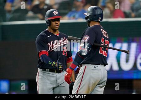 Washington Nationals' Nelson Cruz, left, walks past Texas Rangers starting  pitcher Dane Dunning, right, on his way to the dugout after being thrown  out at home while trying to score on a