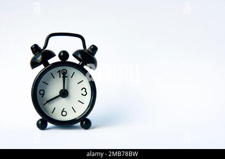 Alarm clock pointing at 8 am or pm with customizable space for text or ideas. Copy space and time concept. Stock Photo