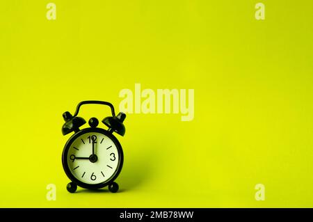 Alarm clock pointing at 9 am or pm with customizable space for text or ideas. Copy space and time concept. Stock Photo