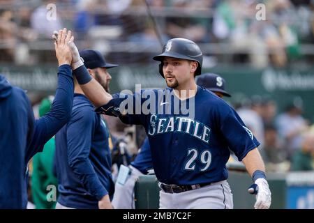 Seattle Mariners' Cal Raleigh (29) is greeted by Eugenio Suárez after  hitting a two-run home run against Baltimore Orioles starting pitcher Kyle  Gibson during the first inning of a baseball game Friday