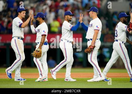 Texas Rangers' Corey Seager, left, Adolis Garcia, center, and Marcus Semien  celebrate the team's 5-2 win over the Chicago White Sox after a baseball  game Monday, June 19, 2023, in Chicago. (AP