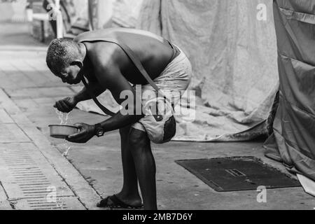 Salvador, Bahia, Brazil - February 09, 2018: People washing in the street after Carnival night in the city of Salvador, Bahia. Stock Photo