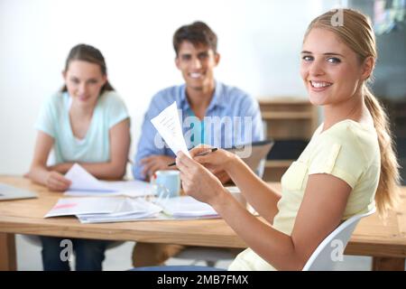 My team is awesome. three colleagues working in an office. Stock Photo