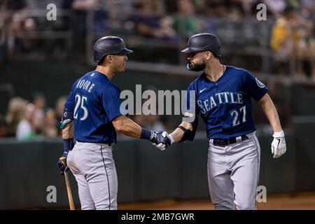 Seattle Mariners 'Jesse Winker (27) celebrates with Dylan Moore (25) after  hitting a solo home run against the Oakland Athletics during the seventh  inning of a baseball game in Oakland, Calif., Tuesday