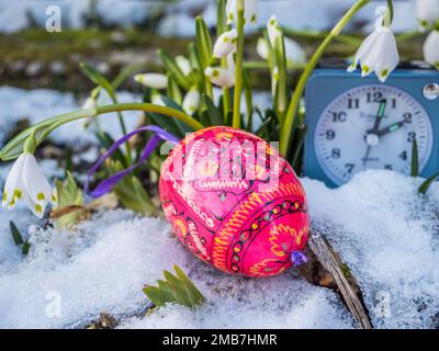 Easter eggs lie in the snow Stock Photo