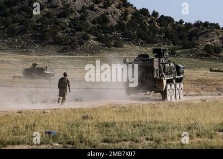 A soldier assigned to Bravo Company, 52nd Brigade Engineer Battalion, 2nd Stryker Brigade Combat Team, 4th Infantry Division, runs toward an M1132 Engineer Squad Vehicle after making a lane during engineer qualification tables, June 14, 2022, at Ft. Carson, Colo. Engineer qualification tables allow soldiers in the unit to demonstrate their proficiency at engineer tasks. U.S. Army photo by Maj. Jason Elmore. Stock Photo