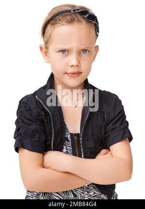 Portrait, angry and children with an unhappy girl standing arms crossed in studio isolated on a white background. Kids, attitude and frown with a Stock Photo