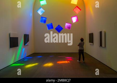Interior of Ellsworth Kelly's AUSTIN at Blanton Museum, Austin, TX as visitor admires stained glass. Stock Photo