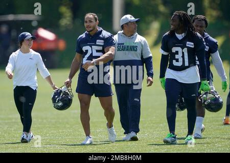 Seattle Seahawks running back Travis Homer (25) toplles over Pittsburgh  Steelers safety Tre Norwood (21) on a run during the first half of an NFL  preseason football game, Saturday, Aug. 13, 2022