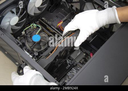 top view mechanic installing graphics card Stock Photo
