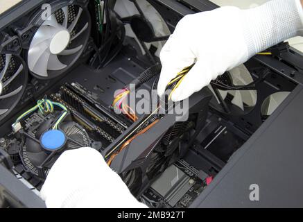 top view mechanic installing graphics card Stock Photo