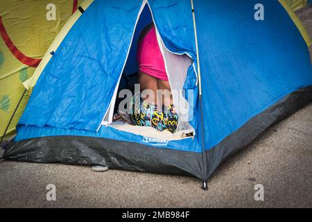 Salvador, Bahia, Brazil - February 09, 2018: Street vendor sleeping on the street after Carnival night in the city of Salvador in Bahia. Stock Photo