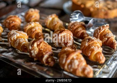 High angle of many delicious small croissants placed on tray in bakery shop Stock Photo