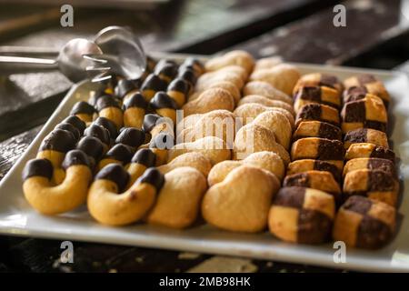 High angle of fresh homemade baked shortbread cookies horseshoe heart and square shaped Stock Photo