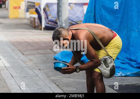 Salvador, Bahia, Brazil - February 09, 2018: People washing in the street after Carnival night in the city of Salvador, Bahia. Stock Photo