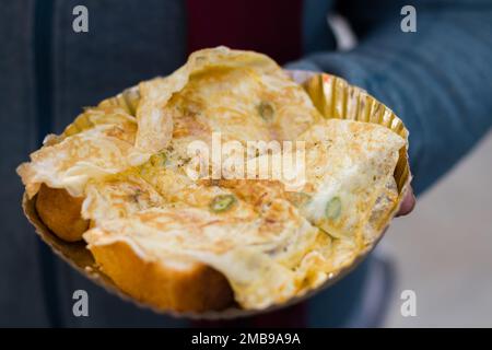 egg toast or egg sandwich made with bread and fried egg omelette served on a paper plate as breakfast or snack in kolkata india. It is a very popular Stock Photo