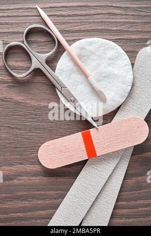 Vertical image with manicure equipment and instruments on the wooden table. Salon desk closeup view Stock Photo