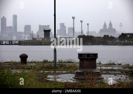 Looking across the East Float dock in Birkenhead, part of the Wirral Waters development, towards the Liver Building across the river Mersey in Liverpool. Wirral Waters will form part of the Liverpool City Region Freeport, which was announced recently by the Conservative government. Stock Photo