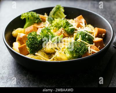 Gnocchi with Broccoli, Broccoli Stem & Basil Pesto and Vegan sausages Stock Photo