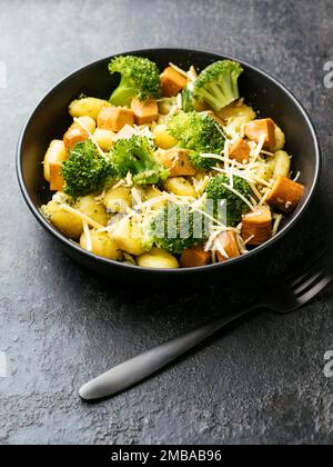 Gnocchi with Broccoli, Broccoli Stem & Basil Pesto and Vegan sausages Stock Photo