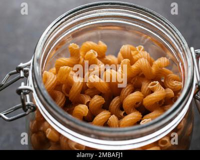Jar with organic lupine pasta, wholemeal pasta with lupine flour. Stock Photo