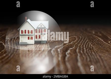 Model House on a Wooden Table Under a Protective Bubble. Stock Photo