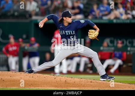 Seattle Mariners relief pitcher Penn Murfee watches a throw to a ...