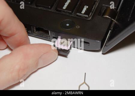 laptop sim slot insert Internet sim card Stock Photo