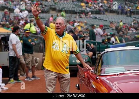 Reggie Jackson waves during a celebration of the Oakland Athletics' 1972  World Series winning team before a baseball game between the Athletics and  the Boston Red Sox in Oakland, Calif., Saturday, June