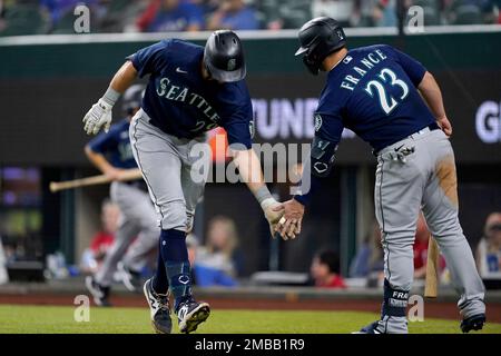 Seattle Mariners' Cal Raleigh reacts after hitting a walk-off single to win  the game 1-0 over the New York Yankees as teammate Julio Rodriguez (44)  runs towards him in a baseball game