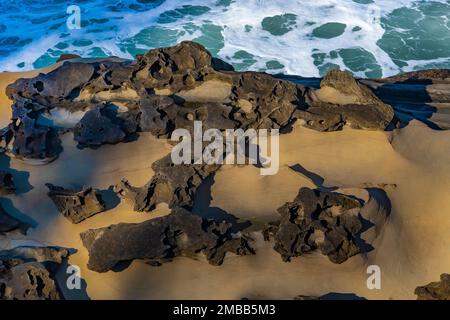 Powerful waves crashing on sandstone cliffs with honeycomb weathering at Shore Acres State Park on the Oregon Coast, USA Stock Photo