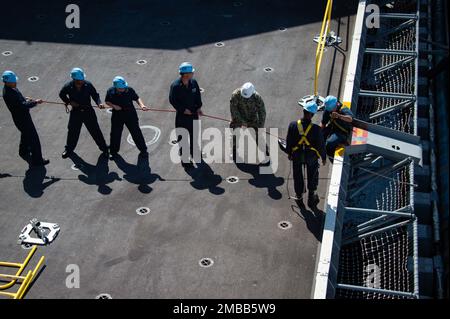 220614-N-TD381-1225 SAN DIEGO (June 14, 2022) Sailors assigned to Nimitz-class aircraft carrier USS Carl Vinson (CVN 70) lower an elevator safety net in preparation for attachment to the enlisted brow, June 14. Vinson is currently pierside in its homeport of San Diego. Stock Photo