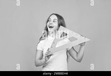 cheerful child with math triangle measuring tool Stock Photo