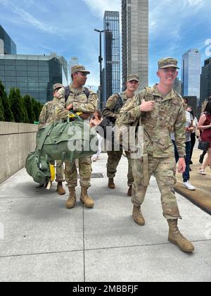 New York Army National Guard Soldiers assigned to the 1st Battalion, 69th Infantry head for buses taking them to   Fort Drum, New York, for pre-deployment training   outside the Jacob Javits Convention Center in New York, following a farewell ceremony on June 14, 2022. The battalion’ Soldiers will be deploying to the Horn of Africa to conduct security missions there. Stock Photo